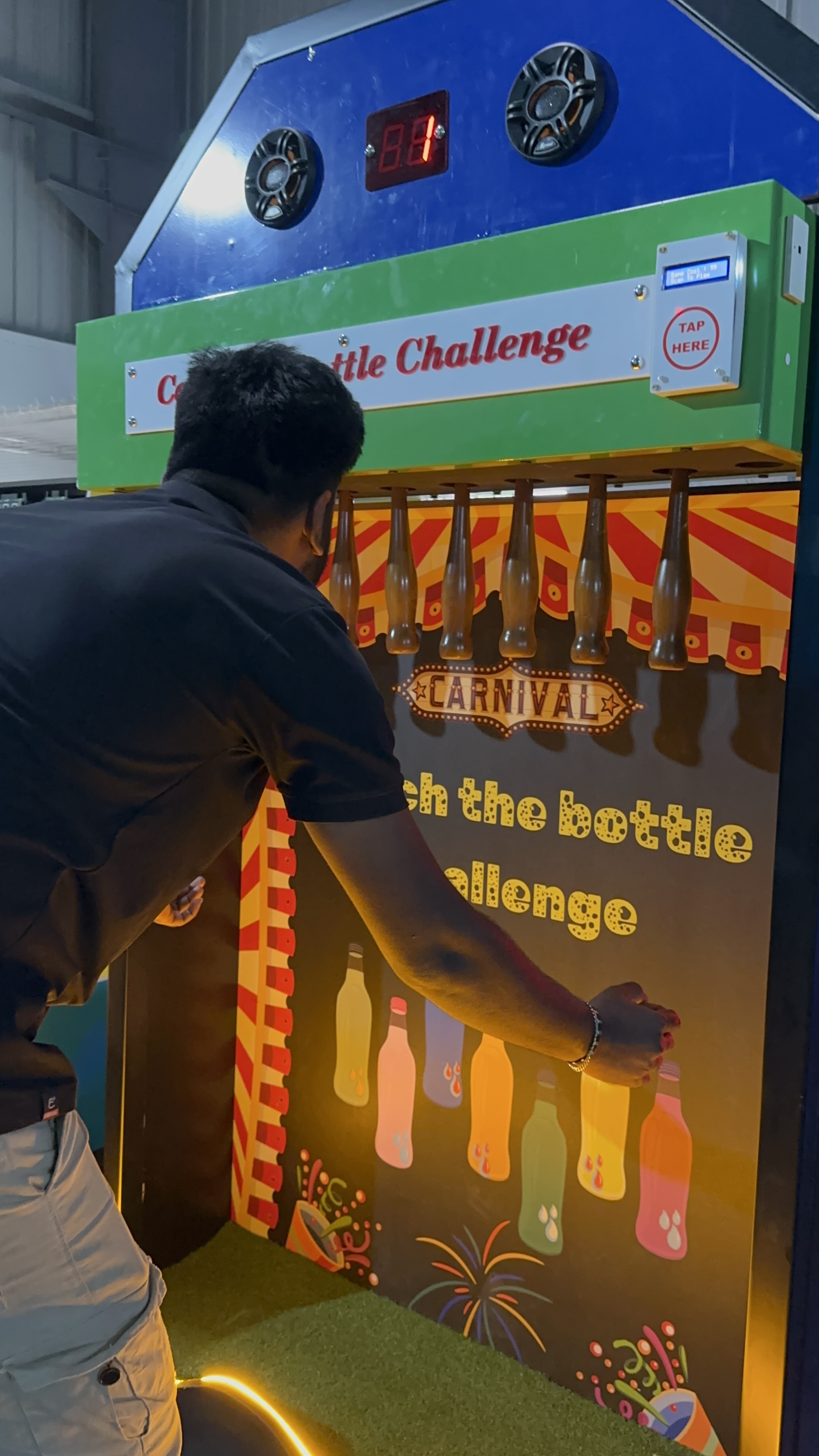 Motorized bottle release mechanism, precision drop system, arcade lighting