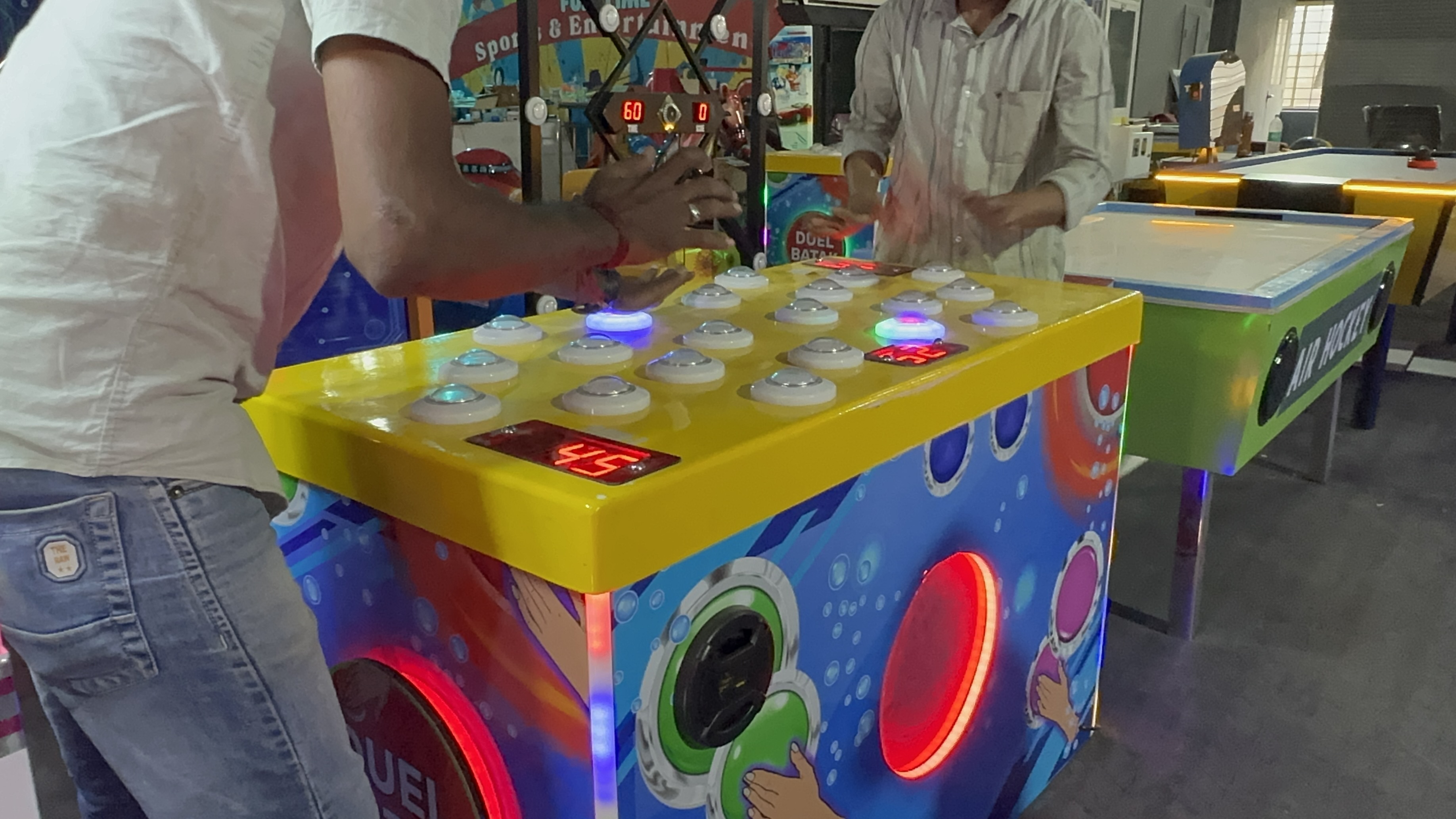 duel batak reaction game in action, two players competing on LED target panels, head-to-head arcade battle, dynamic lighting, professional photography