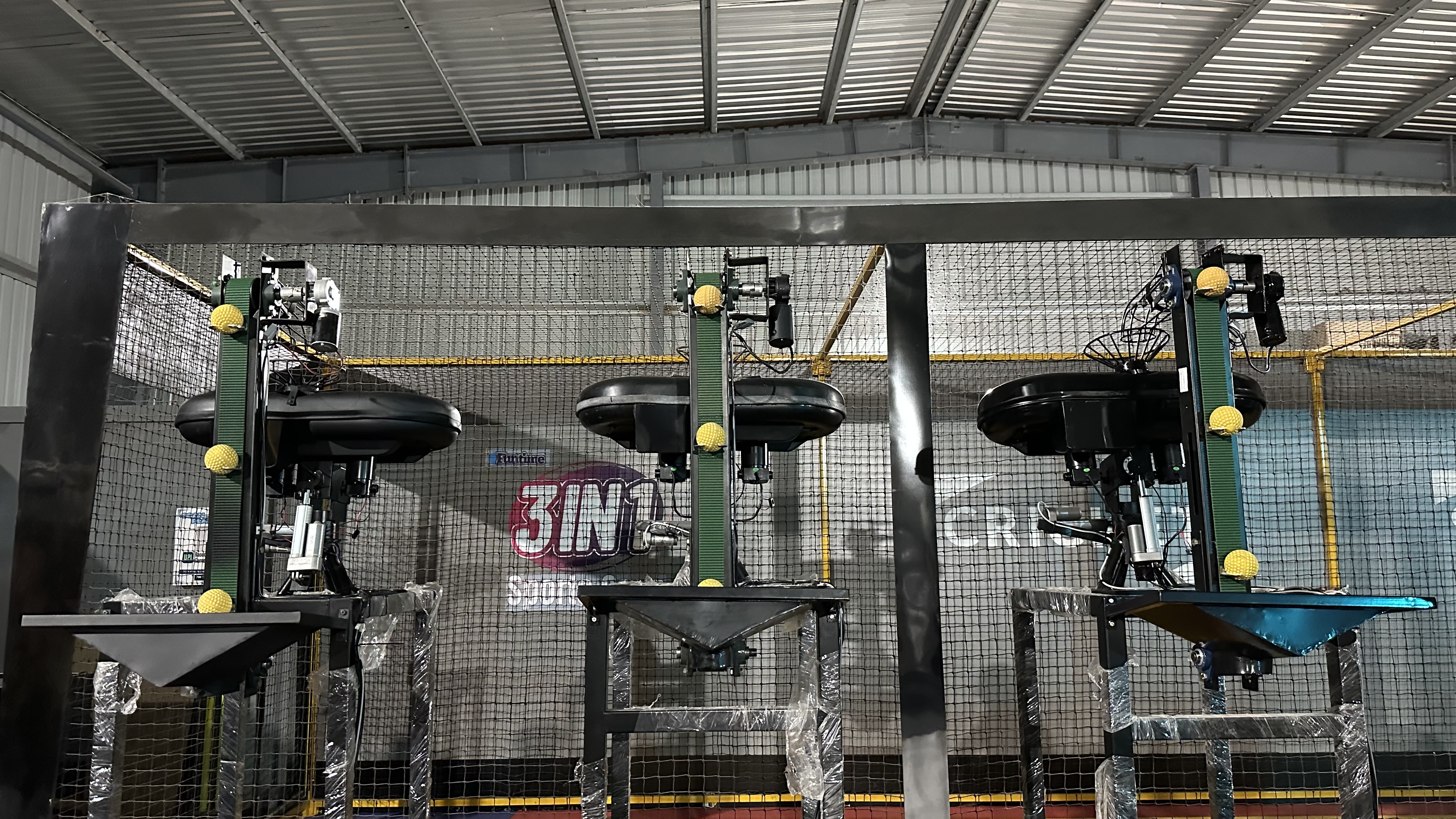 manufacturing assembly line, workers assembling arcade machines, quality control process, industrial setting, professional lighting