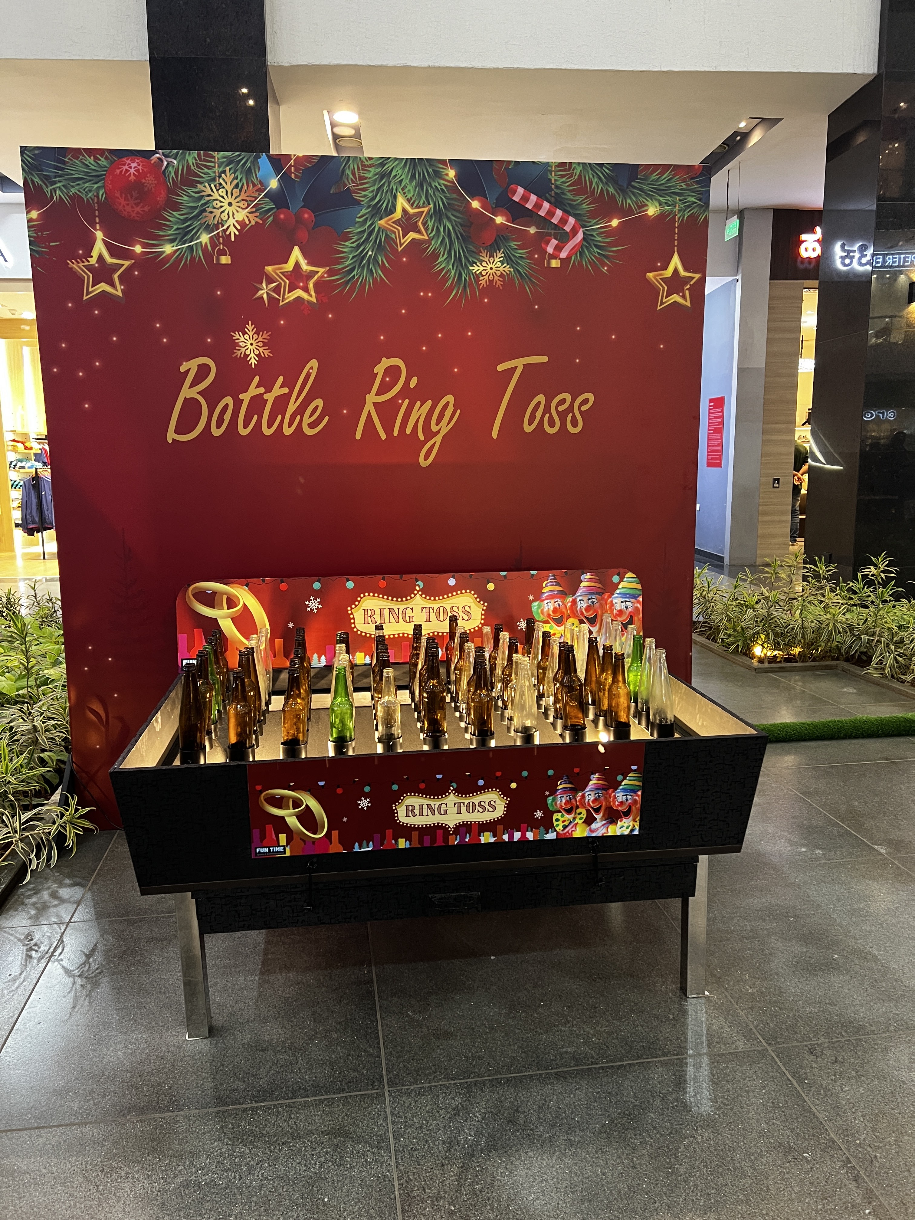 ring toss carnival game in action, player throwing rings at pegs, colorful booth setup, family entertainment center, bright lighting, professional photography