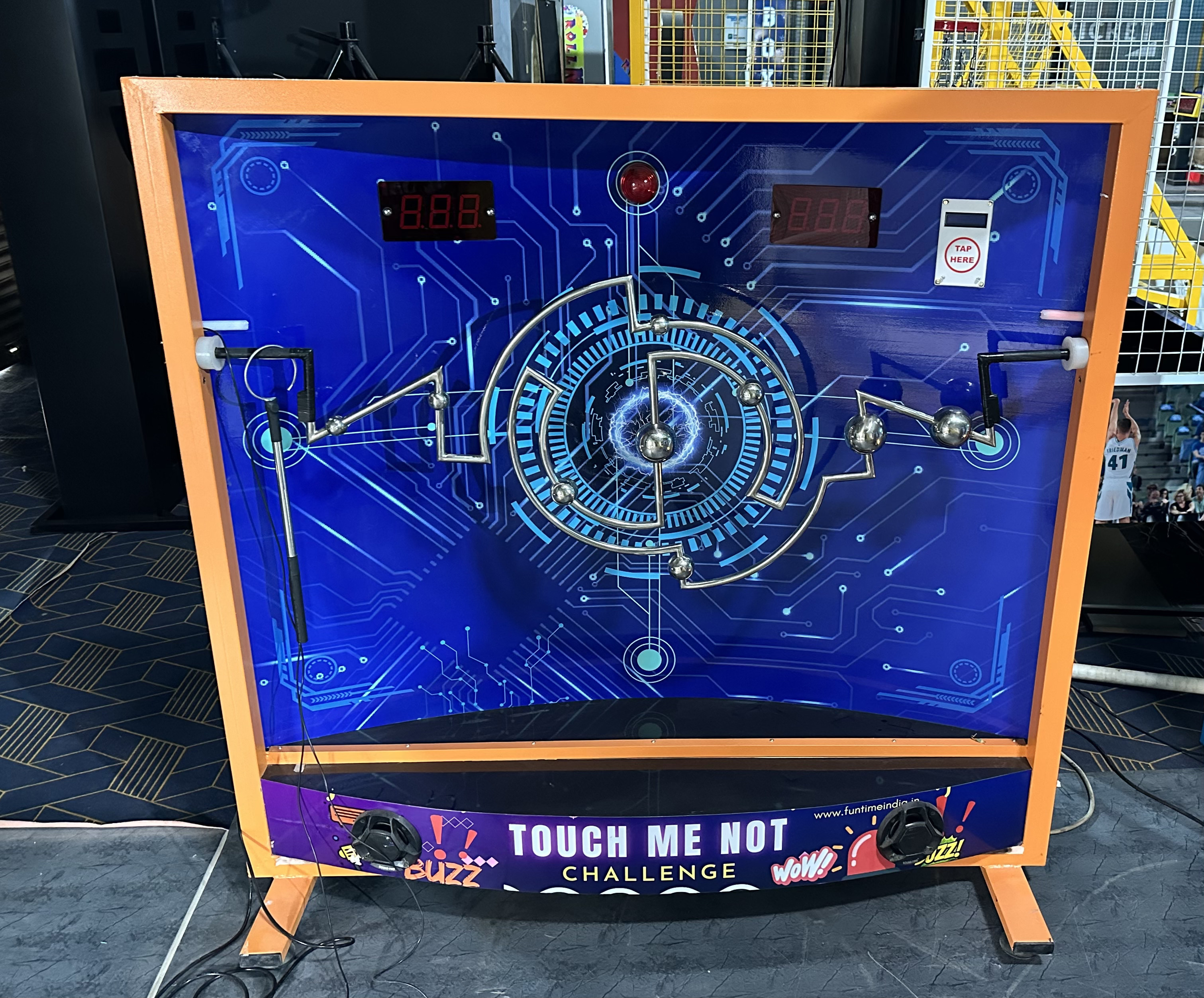 Touch Me Not Challenge game in action, player navigating illuminated rods, LED obstacle grid, trampoline park setting, vibrant lighting, professional photography